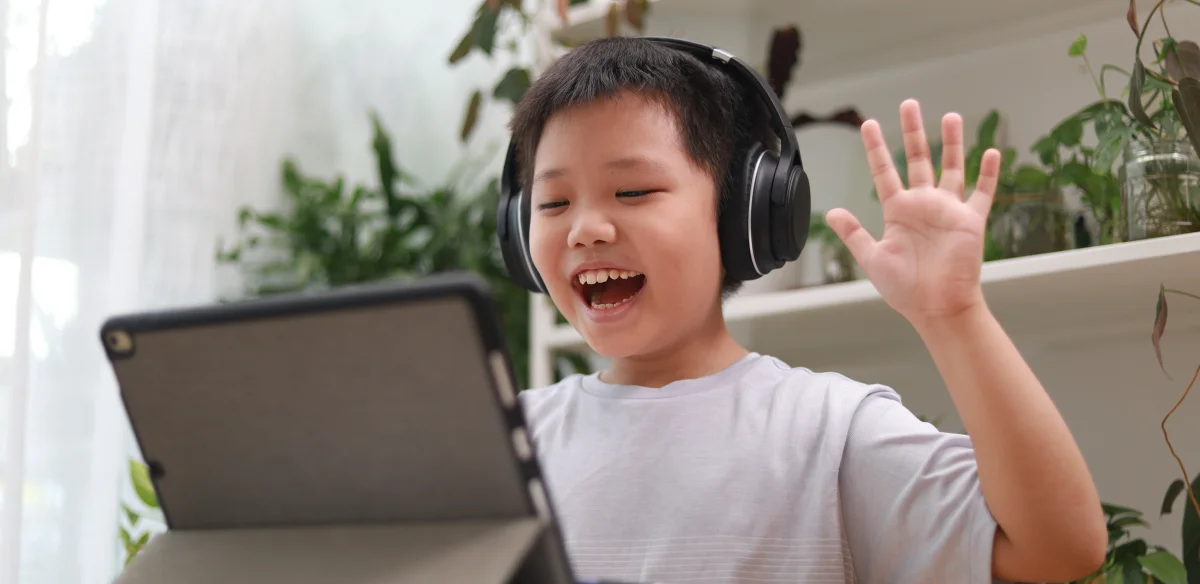 happy boy with headset looking the computer